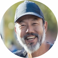 Smiling portrait of James T., a 47-year-old Boston Qualifier, who shares his positive experience with the pacing strategy guide.